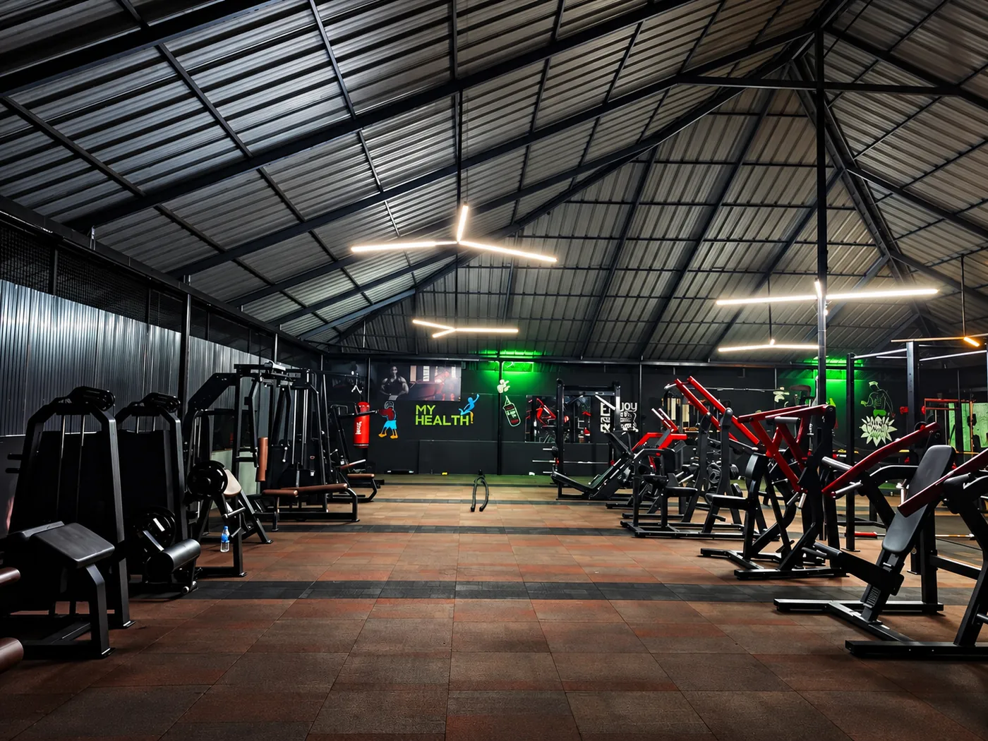 Open training floor at the Kottarakkara gym, with machines along both sides